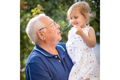 Grandfather holding his grand child in his arms